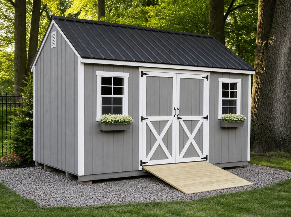 Gray board-and-batten Amish utility shed with white trim and ramp